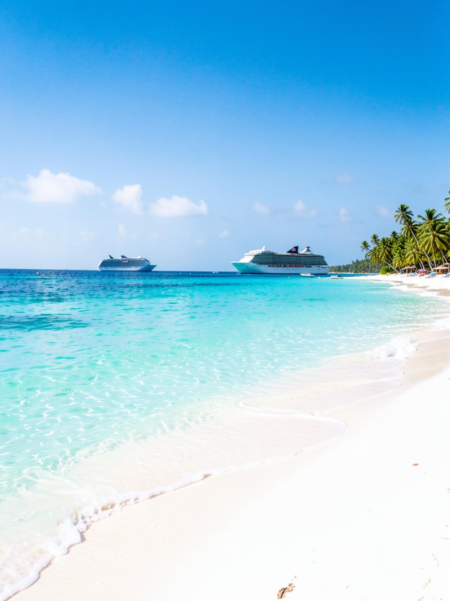 White sand beach with cruise ships anchored offshore